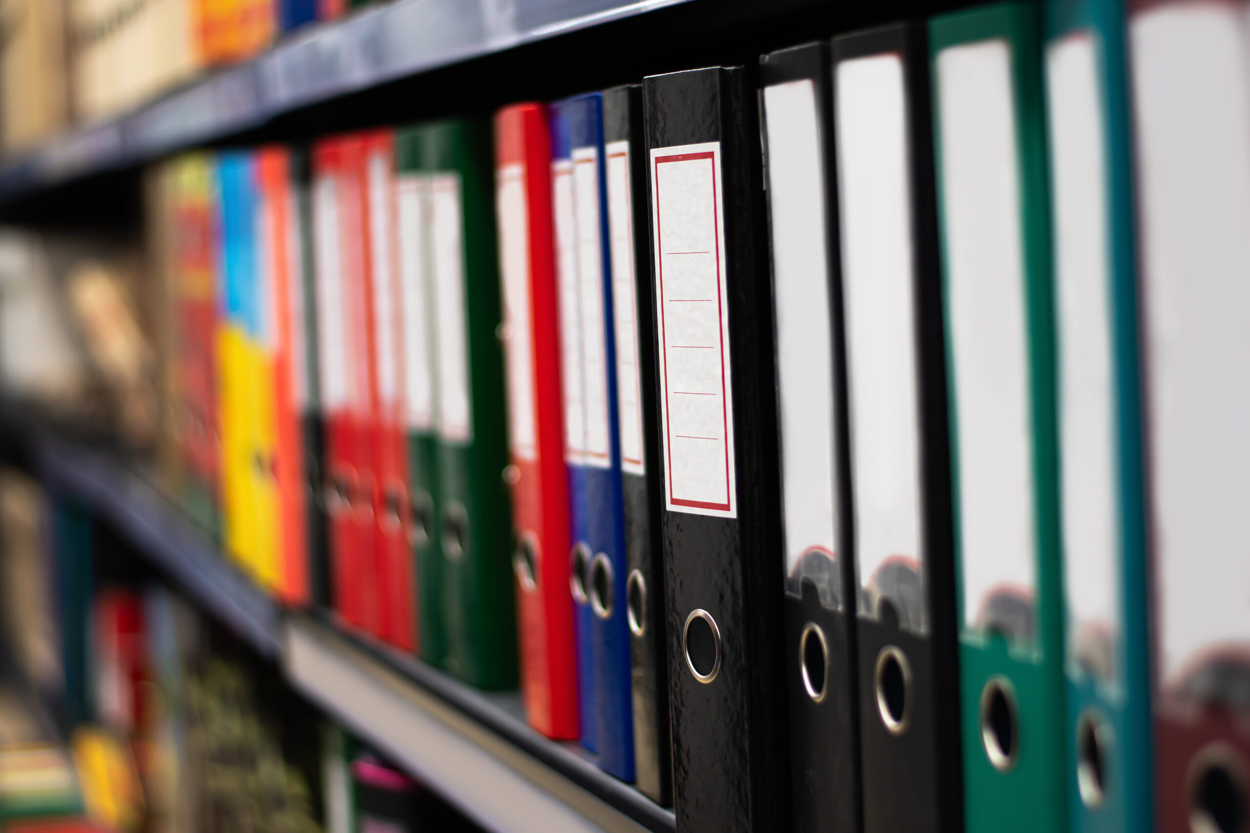 3-ring binders on a shelf