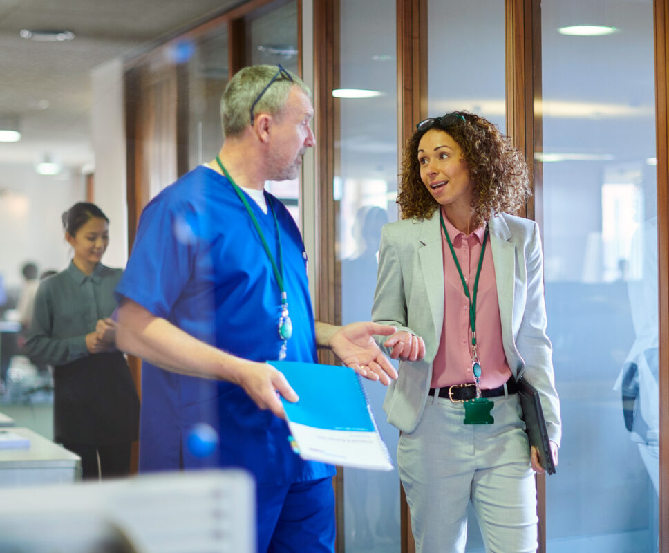 Business person discusses with a medical staff