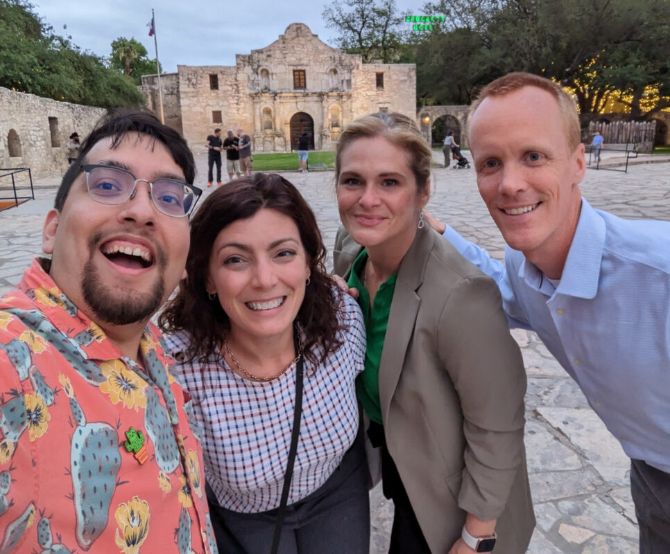 4 people standing in front of the Alamo