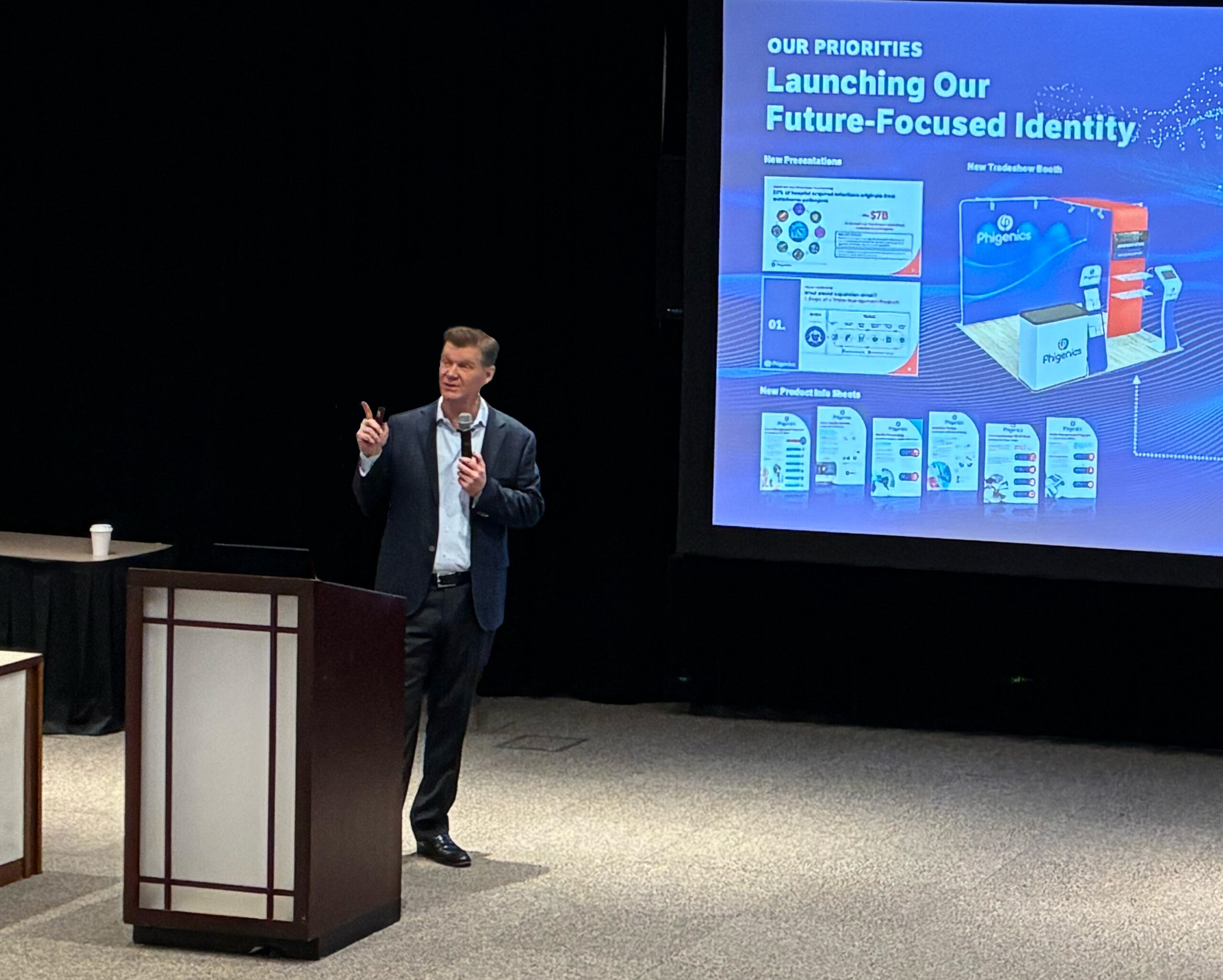 CEO Mark Crockett giving a speech at a podium.